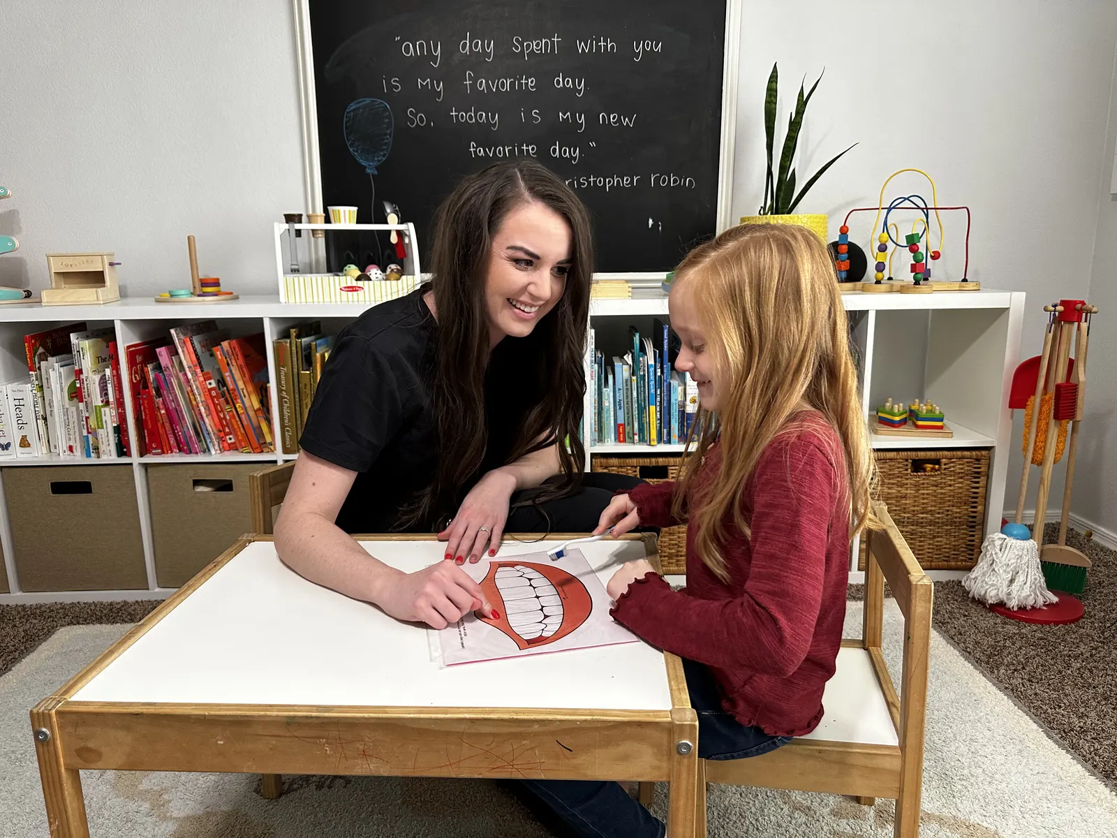A music therapist and a child working together at a table during a virtual-style music therapy activity